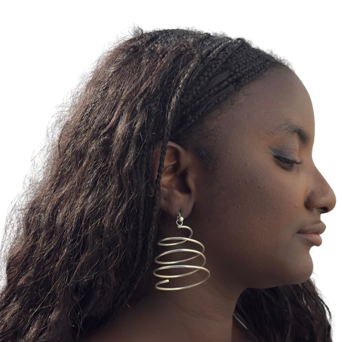 Woman wearing a gold hoop earring with a plain background
